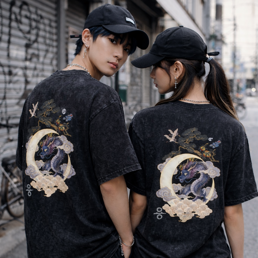 Two people wearing black t-shirts with dragon designs on a street.